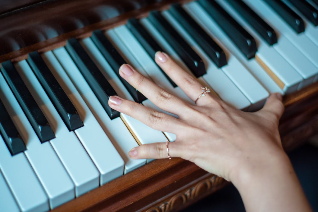Person’s hand on piano keys